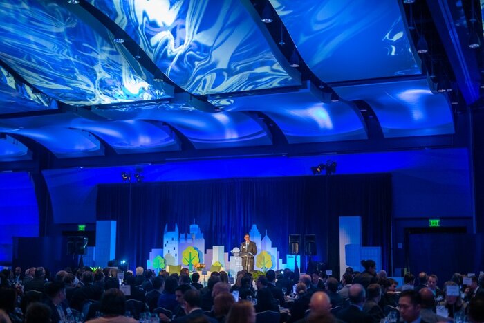 CFA Society Atlanta forecasting dinner in ballroom with cityscape stage design